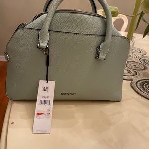 Womens bag, new, sea foam green color with shoulder strap and storage bag.